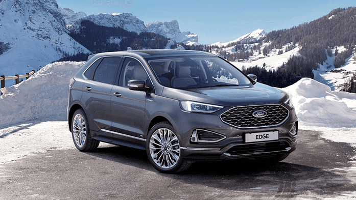 grauer Ford Edge Vignale im Schnee Bergpanorama